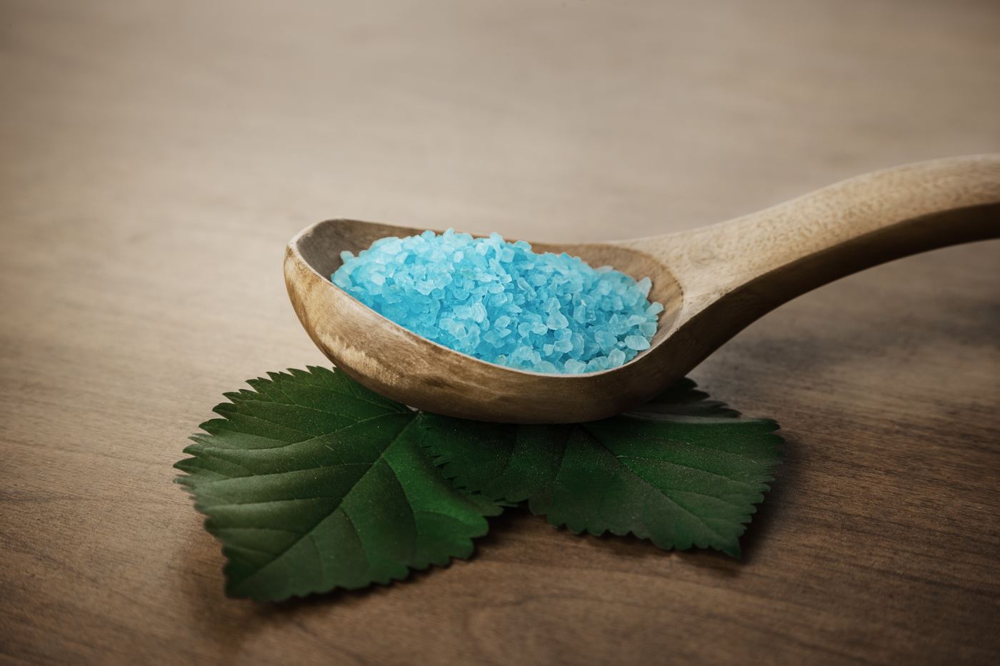 Blue Himalayan bath salt on a wooden spoon